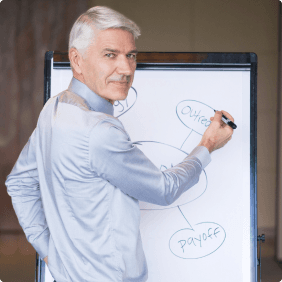 A man writing on a whiteboard